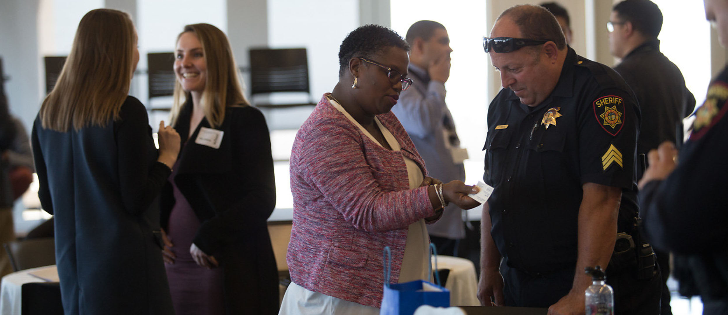 Woman speaks with police officer at event Woman speaks with police officer at event