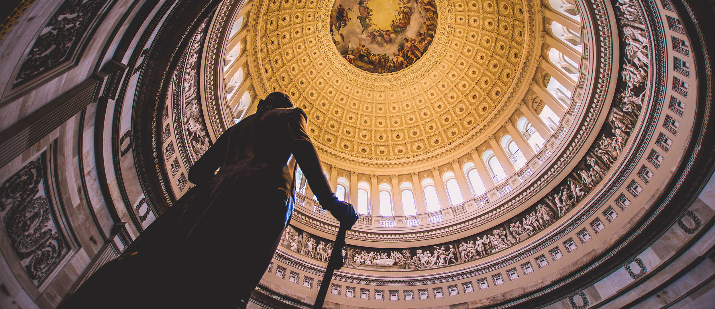 Image of statue inside of court building with golden ceiling Image of statue inside of court building with golden ceiling