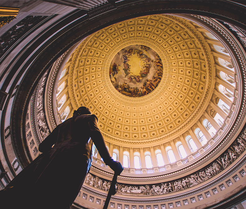 Image of statue inside of court building with golden ceiling