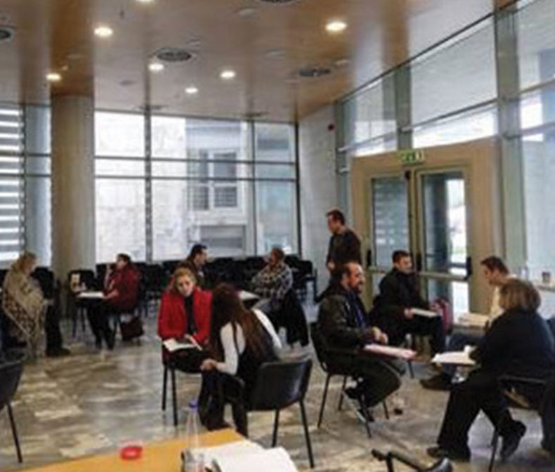 People in a conference room at separate tables