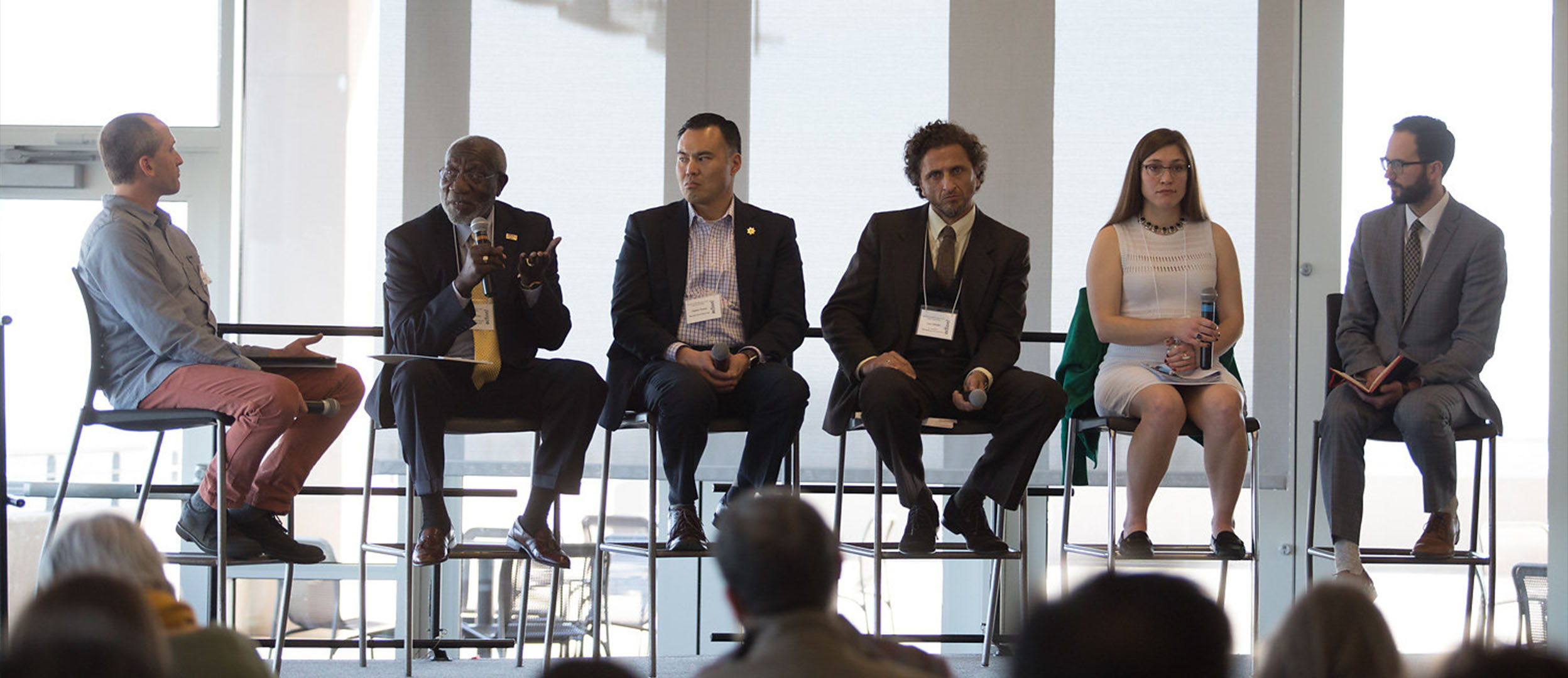 People speaking on a panel People speaking on a panel