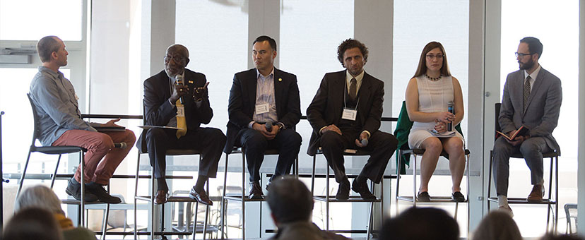 People speaking on a panel People speaking on a panel